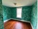 Bedroom featuring painted walls, hardwood floors and natural light from the window at 121 W Young Ave, Henderson, NC 27536