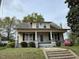 Charming two-story home featuring a covered front porch and traditional architecture at 121 W Young Ave, Henderson, NC 27536
