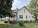 Two-story home featuring traditional design with a well-manicured lawn and mature trees at 121 W Young Ave, Henderson, NC 27536