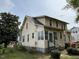 Rear exterior view of a two-story home with a small porch and well-maintained yard at 121 W Young Ave, Henderson, NC 27536