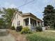 Charming two-story home with covered porch and mature landscaping at 121 W Young Ave, Henderson, NC 27536
