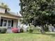 Well-maintained front yard with mature landscaping and flowering shrubs at 121 W Young Ave, Henderson, NC 27536