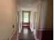 Hallway with access to rooms, and a view of a window at the end at 121 W Young Ave, Henderson, NC 27536