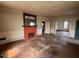Spacious living room with original fireplace and hardwood floors, needs renovation at 121 W Young Ave, Henderson, NC 27536