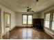 Spacious living room with ceiling fan and lots of natural light, needs renovation at 121 W Young Ave, Henderson, NC 27536