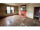 Living room with hardwood floors and a fireplace, needs renovation at 121 W Young Ave, Henderson, NC 27536