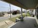 Inviting covered front porch with stately columns and neighborhood views at 121 W Young Ave, Henderson, NC 27536