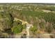 Aerial view of home surrounded by mature trees and open green space at 125 Camden Dr, Youngsville, NC 27596