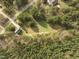 An aerial shot showcasing the wooded lot with a mix of trees and open areas around the home at 125 Camden Dr, Youngsville, NC 27596