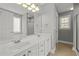 Bathroom featuring double vanity sinks, tiled floors, and ample lighting at 125 Camden Dr, Youngsville, NC 27596