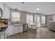 Updated eat-in kitchen featuring white cabinets, granite countertops, and stainless steel appliances with outdoor access at 125 Camden Dr, Youngsville, NC 27596
