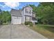 Two-story home with gray siding, attached garage, and a well-manicured lawn at 125 Camden Dr, Youngsville, NC 27596