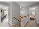 Upstairs hallway with natural light leads to bedrooms and office space at 125 Camden Dr, Youngsville, NC 27596