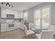 Bright eat-in kitchen featuring white cabinets, granite countertops, and stainless steel appliances near a dining area at 125 Camden Dr, Youngsville, NC 27596