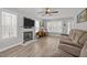 Inviting living room with a fireplace, large windows, and neutral tones at 125 Camden Dr, Youngsville, NC 27596