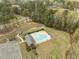 Aerial shot of a community pool surrounded by a parking lot and mature trees at 125 Camden Dr, Youngsville, NC 27596