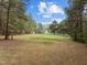 Spacious lot with a home, white fencing, shed, and grassy field at 125 Camden Dr, Youngsville, NC 27596