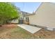 Home's backyard featuring a concrete patio and double doors at 1306 Ed Cook Rd, Durham, NC 27703