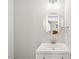 Modern bathroom featuring a vanity with a sink, round mirror, and modern lighting fixture at 1306 Ed Cook Rd, Durham, NC 27703
