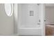 Bright bathroom with tiled shower and round window at 1306 Ed Cook Rd, Durham, NC 27703
