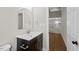 Modern bathroom with sleek vanity, mirror, and tiled walls at 1306 Ed Cook Rd, Durham, NC 27703