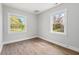 Bedroom with light wood floors, neutral paint and two large windows overlooking the backyard at 1306 Ed Cook Rd, Durham, NC 27703