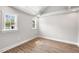 Bright bedroom featuring hardwood floors, white trim and two windows allowing for natural light at 1306 Ed Cook Rd, Durham, NC 27703