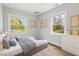 Light, airy bedroom with two windows and cheerful decor, plus a comfortable bed and dresser at 1306 Ed Cook Rd, Durham, NC 27703