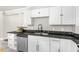The kitchen features white cabinets, dark countertops, and stainless steel appliances at 1306 Ed Cook Rd, Durham, NC 27703