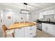 This spacious kitchen boasts an island with seating, white cabinets, and stainless steel appliances at 1306 Ed Cook Rd, Durham, NC 27703