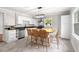 Bright kitchen features stainless steel appliances, black countertops, and a large island with seating at 1306 Ed Cook Rd, Durham, NC 27703