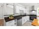 Bright kitchen features stainless steel appliances, black countertops, and white cabinets at 1306 Ed Cook Rd, Durham, NC 27703
