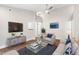 Cozy living room with hardwood floors, gray sofa, chairs, and glass coffee table at 1306 Ed Cook Rd, Durham, NC 27703