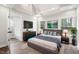 Bright main bedroom features hardwood floors, a closet, and large windows at 1306 Ed Cook Rd, Durham, NC 27703