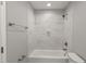 Tiled bathtub and shower with updated fixtures and overhead lighting at 1426 Quarter Pt, Raleigh, NC 27615