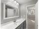 Well-lit bathroom featuring a modern vanity and a glimpse into an adjoining room at 1426 Quarter Pt, Raleigh, NC 27615