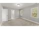This bedroom has two windows, gray carpet, and neutral paint at 1426 Quarter Pt, Raleigh, NC 27615