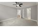 Spacious bedroom with neutral carpet and ceiling fan, adjacent to other rooms and hallway at 1426 Quarter Pt, Raleigh, NC 27615