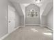 Cozy bedroom with vaulted ceilings, carpet, and a charming arched window at 1426 Quarter Pt, Raleigh, NC 27615