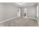 Neutral carpeted bedroom with en suite bathroom and bright gray walls at 1426 Quarter Pt, Raleigh, NC 27615