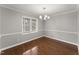 A well-lit dining room featuring hardwood floors and a modern chandelier at 1426 Quarter Pt, Raleigh, NC 27615