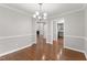 Dining room with hardwood floors, classic chandelier, and views to other rooms at 1426 Quarter Pt, Raleigh, NC 27615