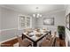Dining room with a stylish table setting, elegant decor, and abundant natural light at 1426 Quarter Pt, Raleigh, NC 27615