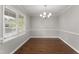 Charming dining room with hardwood floors and an elegant chandelier at 1426 Quarter Pt, Raleigh, NC 27615
