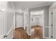 Hallway view of a dining room with hardwood floors, grey walls and white trim at 1426 Quarter Pt, Raleigh, NC 27615