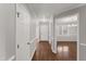 A hallway view of the foyer and dining room, featuring hardwood floors, and natural light at 1426 Quarter Pt, Raleigh, NC 27615