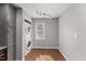 Bright laundry room showcases a stacked washer and dryer, with a window for natural light at 1426 Quarter Pt, Raleigh, NC 27615