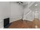 Living room featuring hardwood floors, fireplace, and staircase to second floor at 1426 Quarter Pt, Raleigh, NC 27615