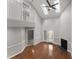 Spacious living room with hardwood floors, skylights, ceiling fan, and fireplace at 1426 Quarter Pt, Raleigh, NC 27615
