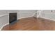 Living room featuring hardwood floors, fireplace, and carpeted staircase to the second floor at 1426 Quarter Pt, Raleigh, NC 27615